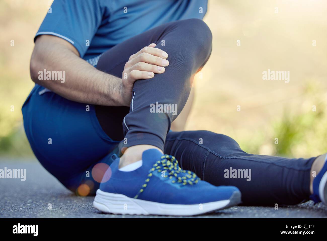 I cant move with this cramp. an unrecognisable man sitting alone and