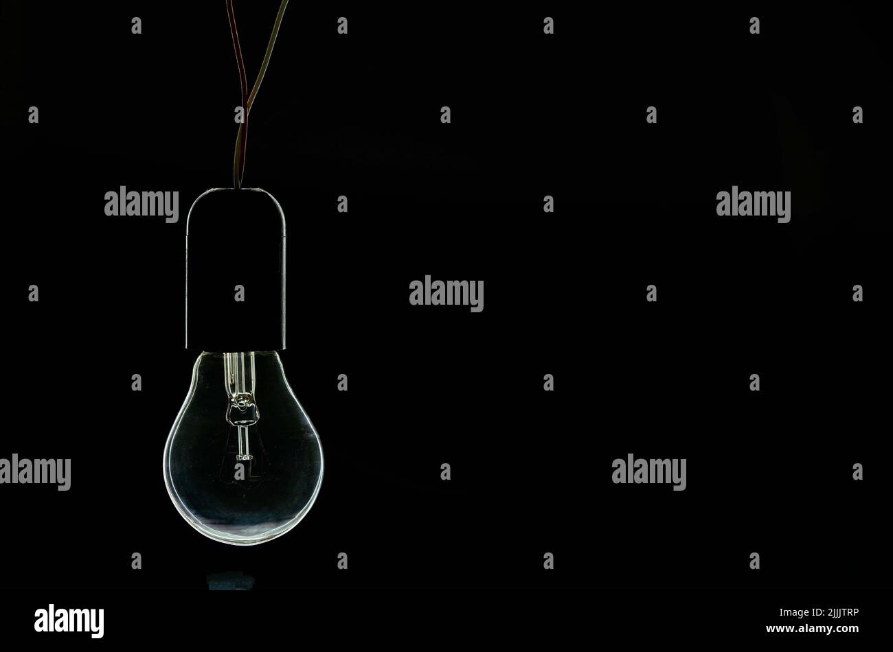turned off incandescent light bulb on a black background Stock Photo