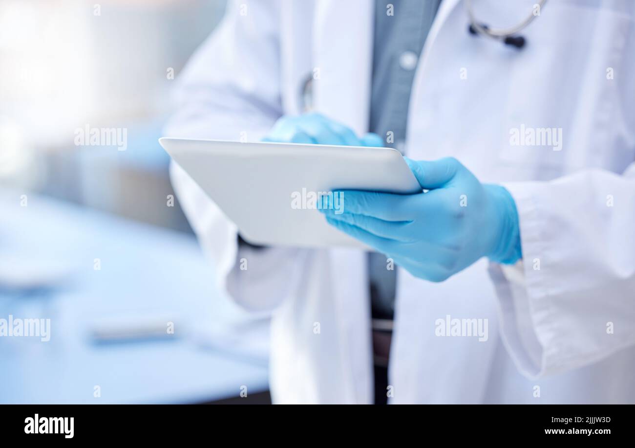 Record keeping is of utmost importance. an unrecognizable male doctor using a digital tablet. Stock Photo