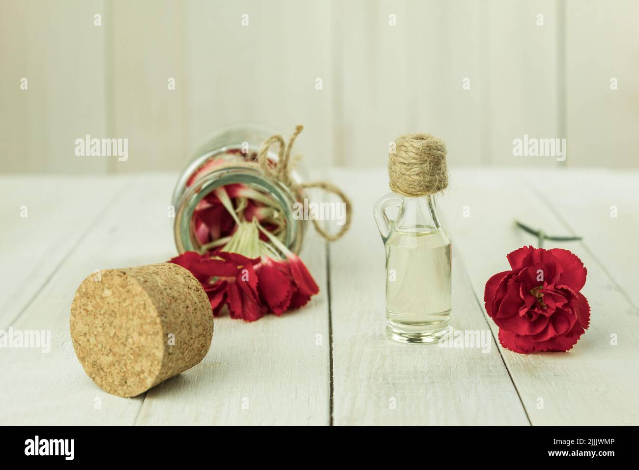 A bottle of aromatic oil made from fresh flower petals. Essential oil