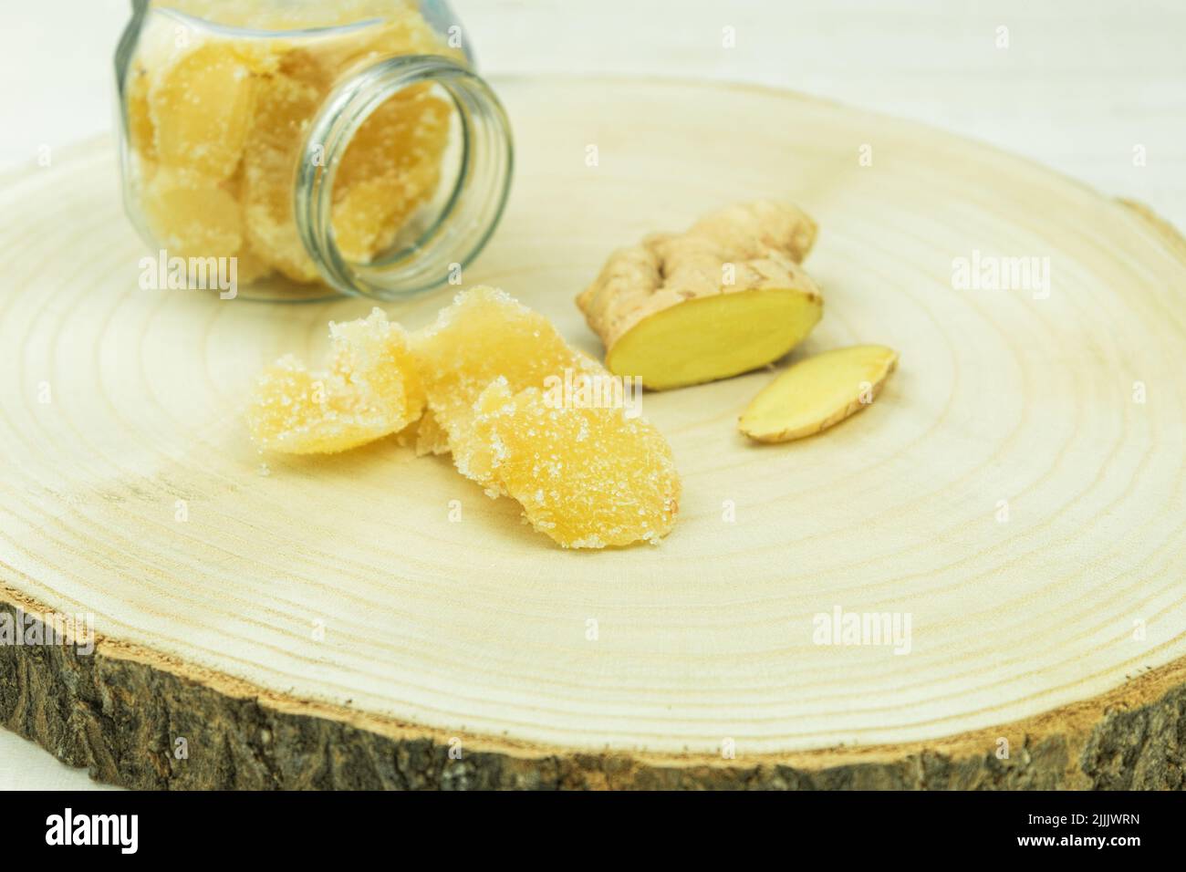 Fresh ginger root and candied ginger in sugar. Closeup of candied