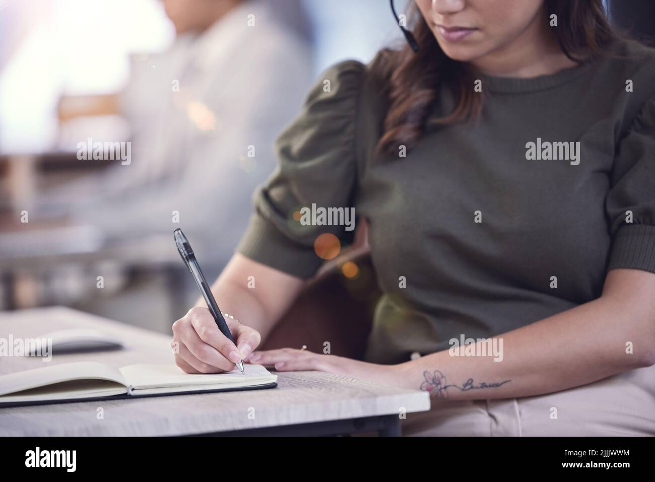 Taking notes is helpful. an unrecognizable call center agent at work ...