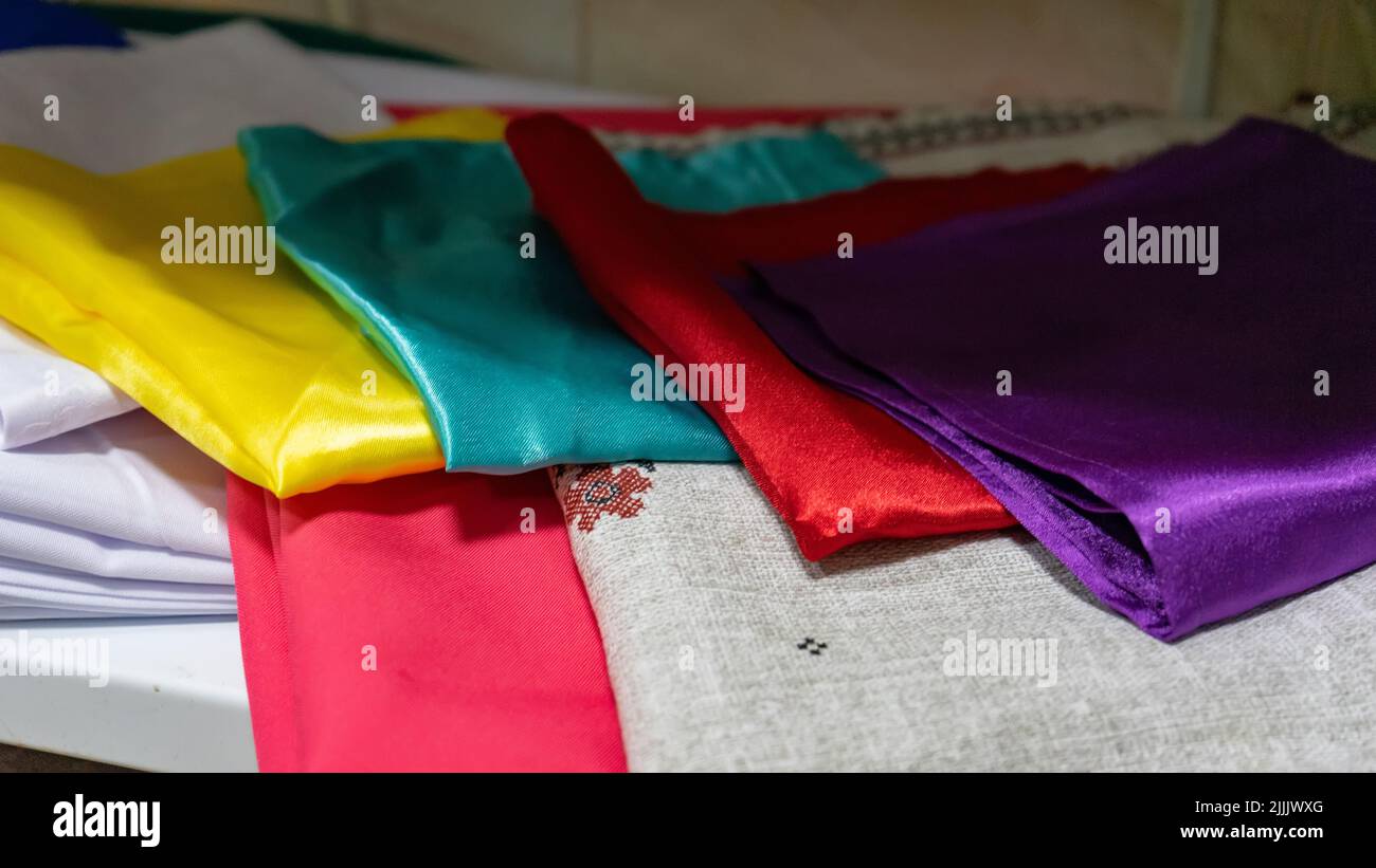 Multicolored kitchen towels lie folded on a shelf Stock Photo