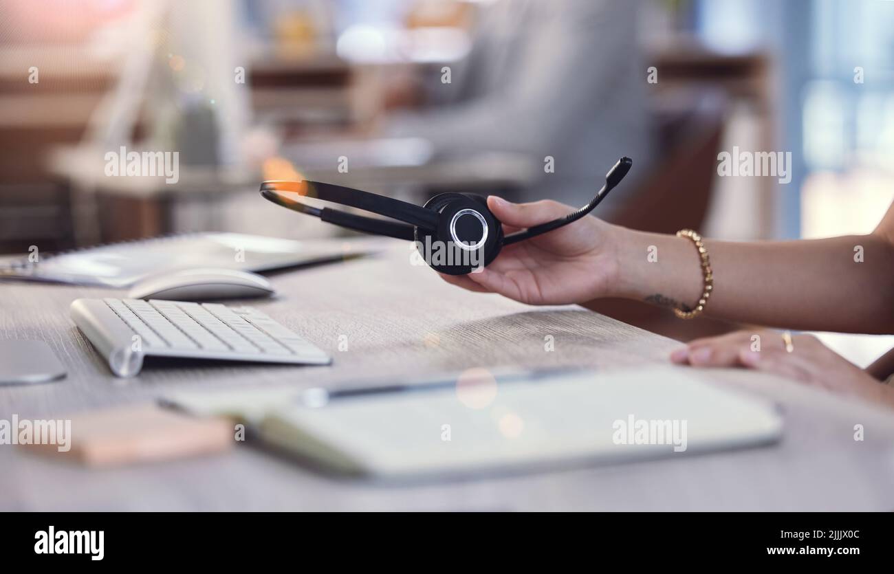 Lets get to work. an unrecognizable call center agent at work. Stock Photo