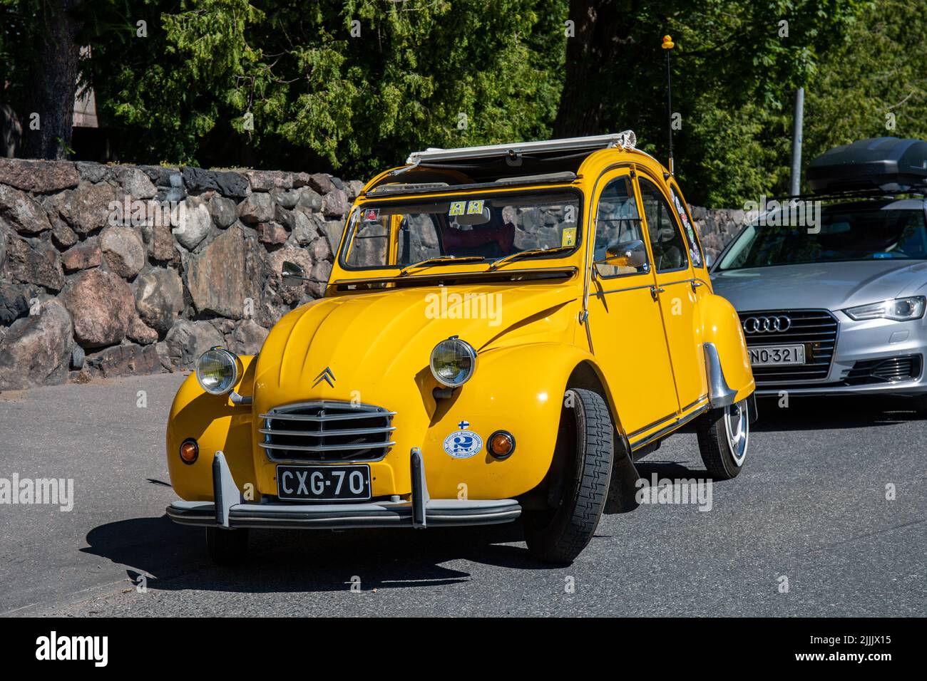 Old yellow Citroën 2CV with open roll-back canvas sunroof in Helsinki, Finland Stock Photo