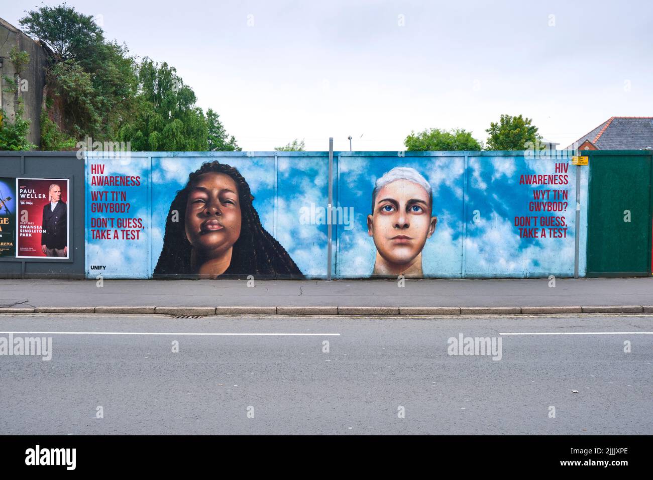 A painted mural, featuring portraits of people, urging citizens to get tested for HIV. In Cardiff, Wales, United Kingdom. Stock Photo