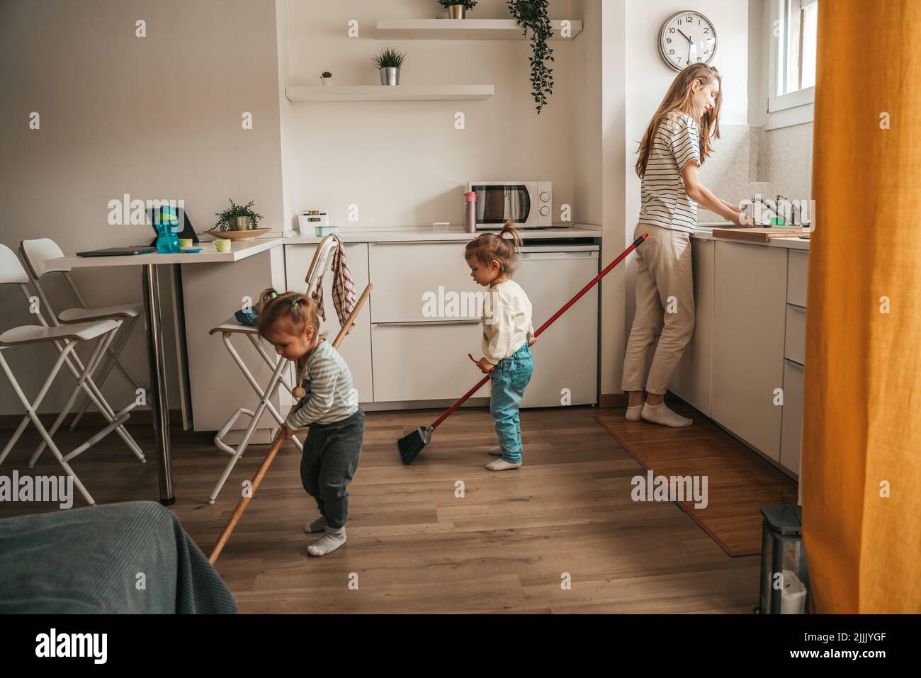 Kids helping their mother to clean the kitchen Stock Photo Alamy