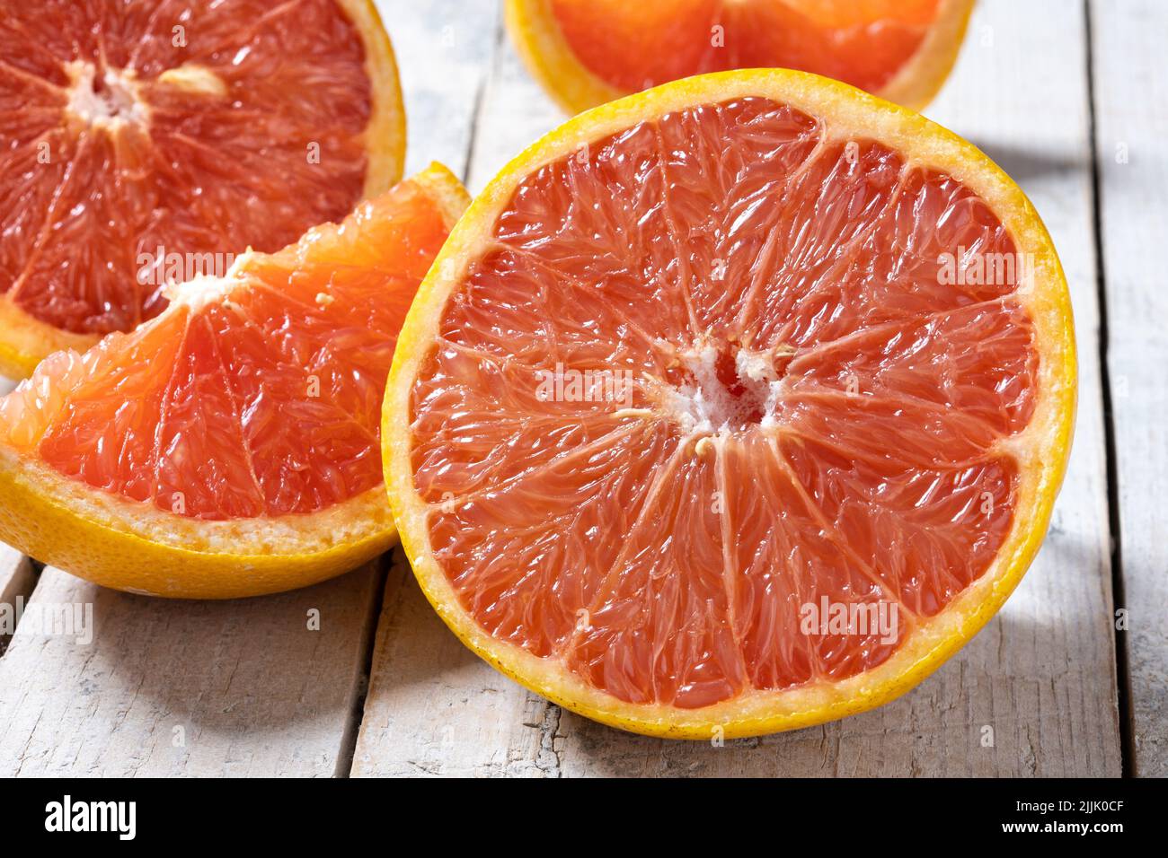 Fresh grapefruit slices on wooden table Stock Photo
