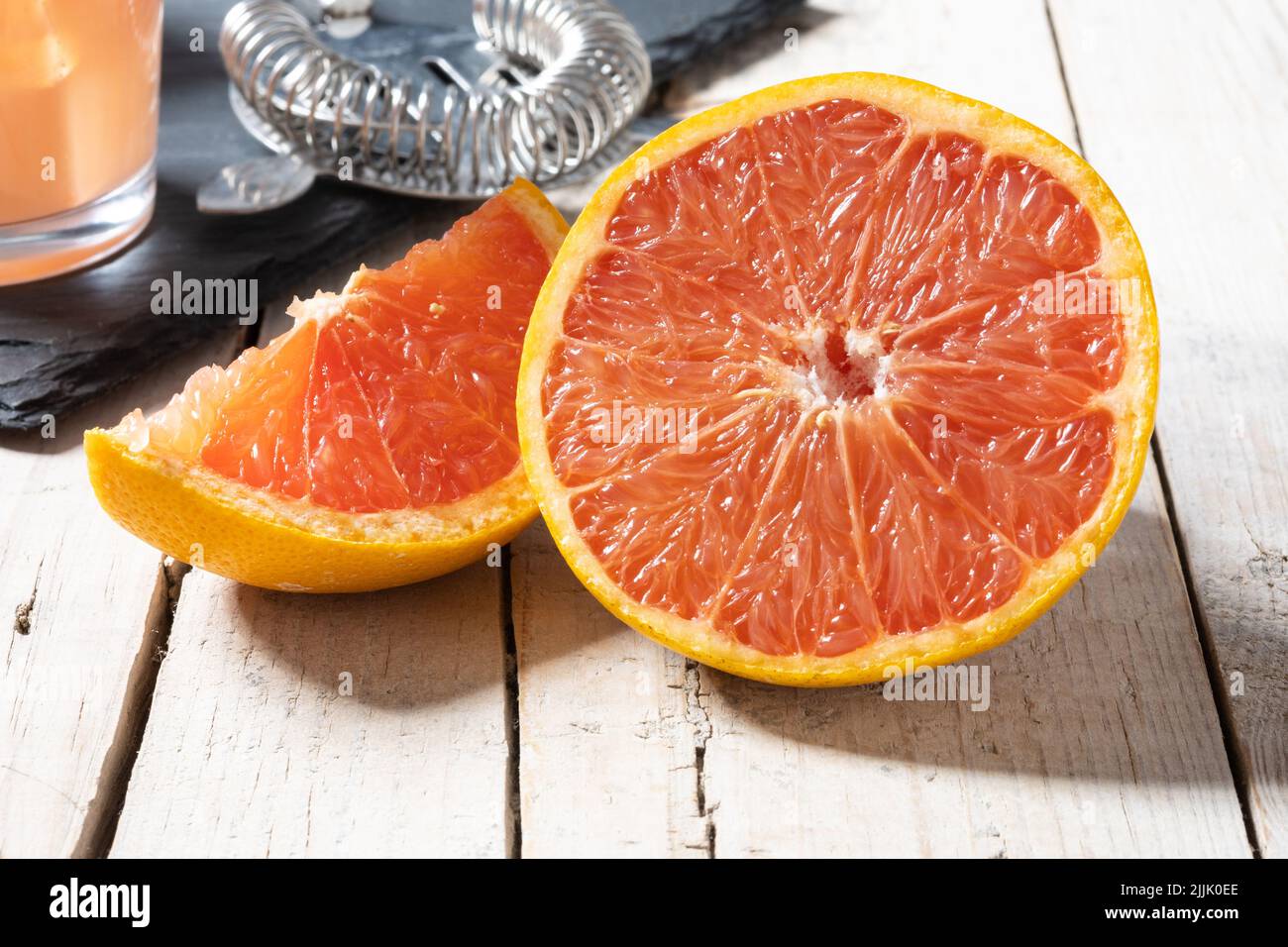 Fresh grapefruit slices on wooden table Stock Photo
