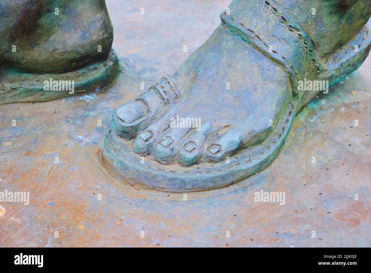 Close up, detail of a humble sandal shoe on the bronze statue of the Indian independence leader, Mahatma Gandhi. In Cardiff, Wales, United Kingdom. Stock Photo