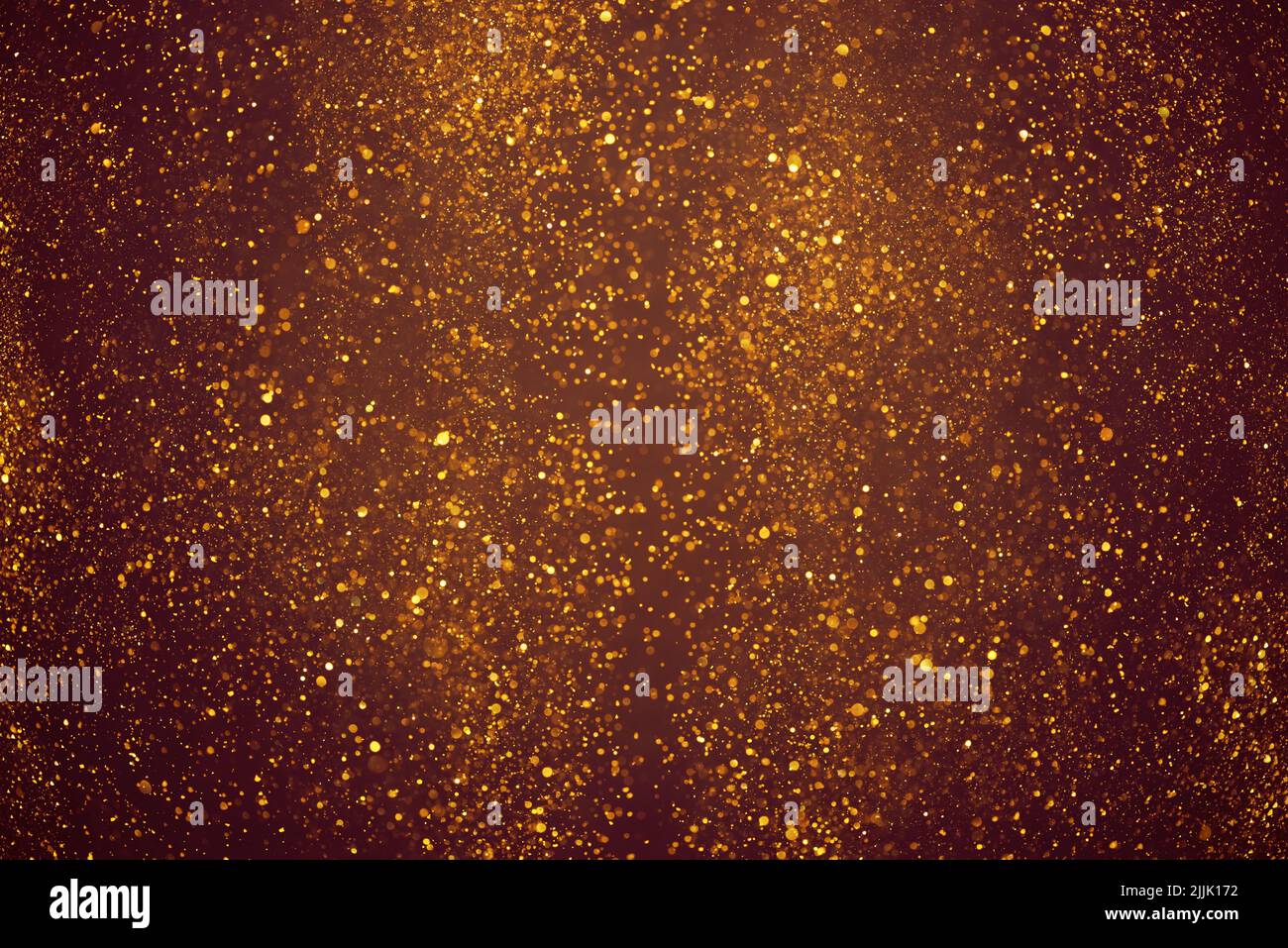 Golden glitter dust festive lights abstract bokeh background Stock Photo