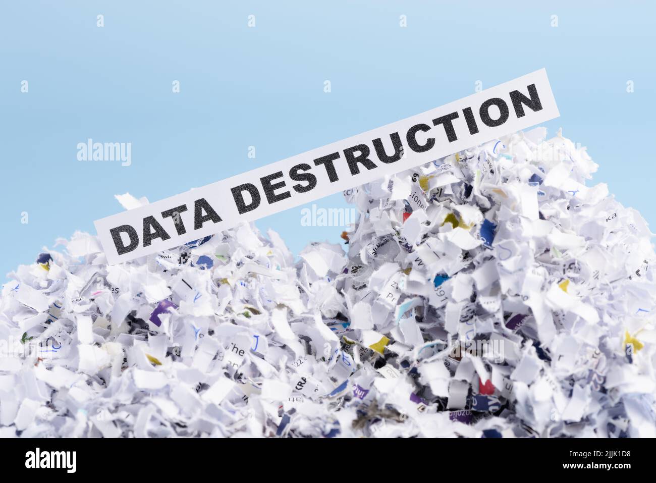 Words Data destruction on top of heap of cross shredded paper concept Stock Photo
