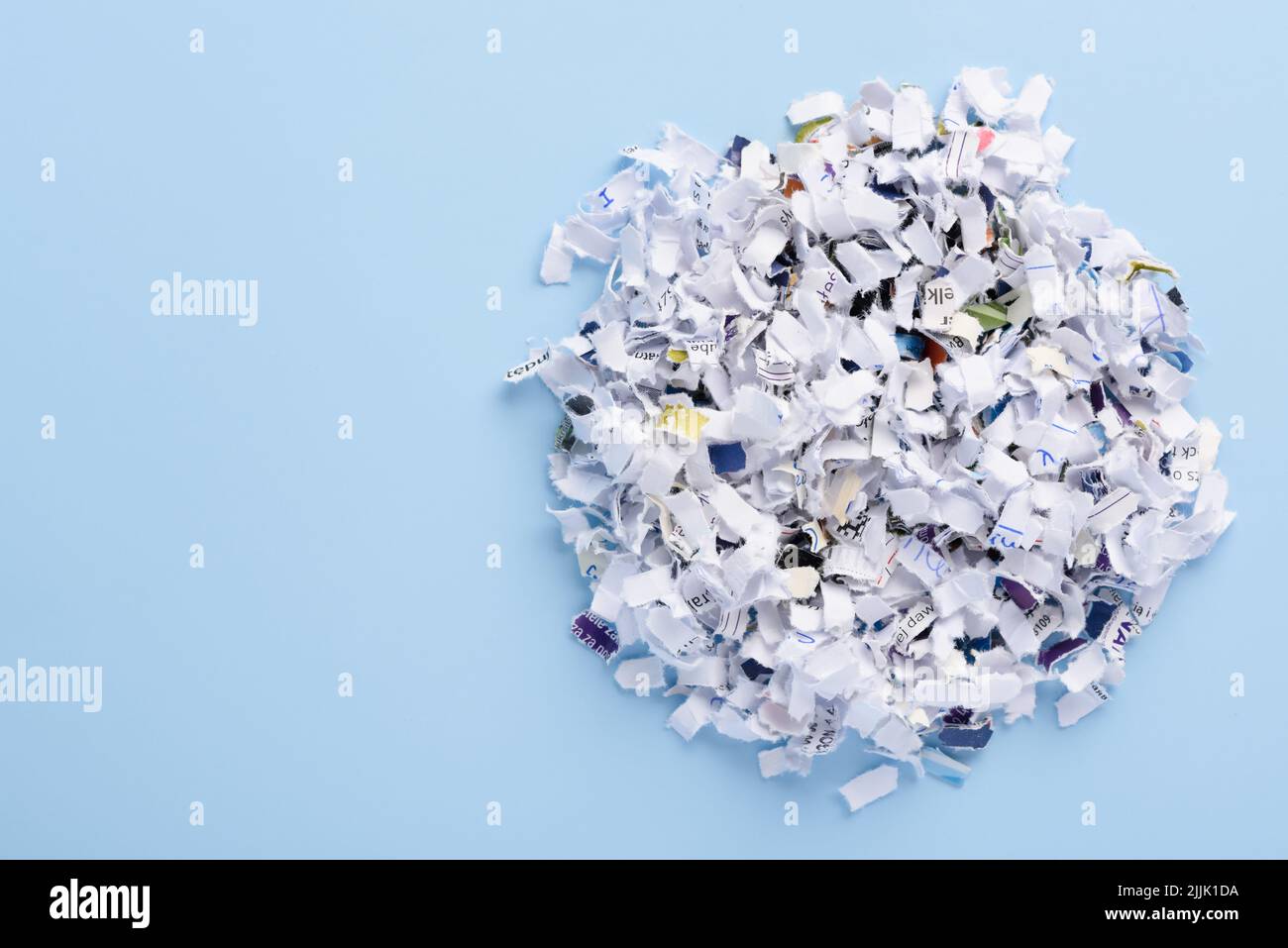 Slashed Out Document Heap of cross cut shredded documents on blue background top view with ...