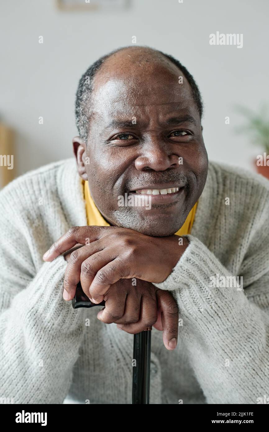 Portrait of African happy senior man with stick smiling at camera Stock Photo