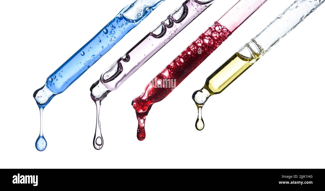 Cosmetic pipette droppers with different colored skincare serum and hanging liquid drop, isolated on white background Stock Photo