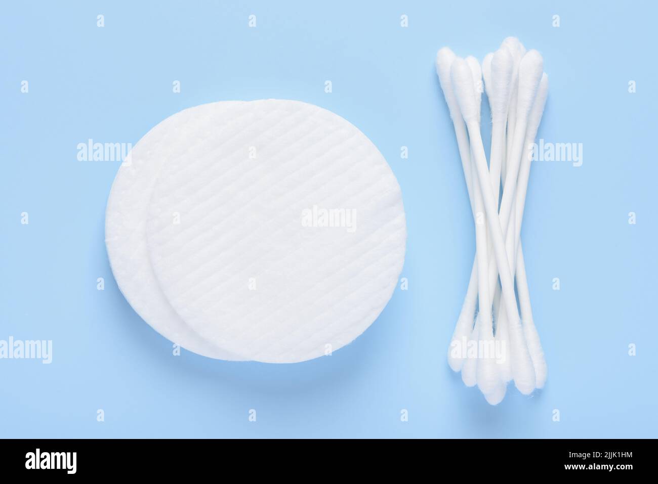White new clean cotton pads and swabs buds on blue background top view flay lay Stock Photo