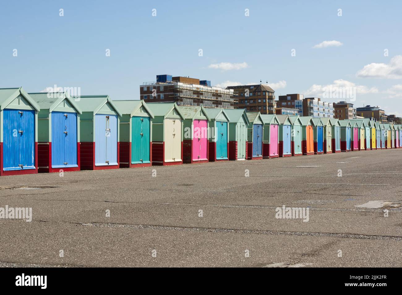 Multicoloured beach huts on the seafront promenade at Hove, Brighton in East Sussex, England Stock Photo
