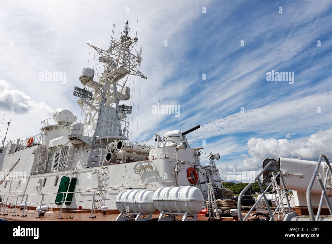 Closeup view of sea warship against cloudy blue sky Stock Photo
