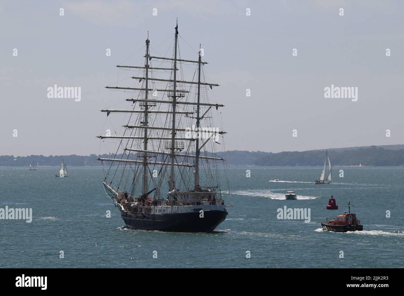 The three masted barque TENACIOUS leaves harbour and heads into The Solent Stock Photo