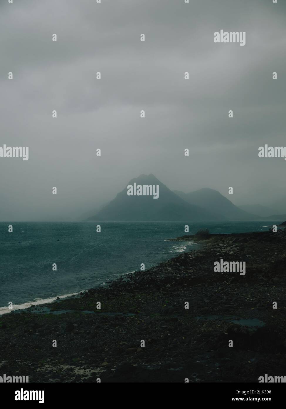 A dark rain cloud blurry coast and minimal mountain landscape Stock Photo