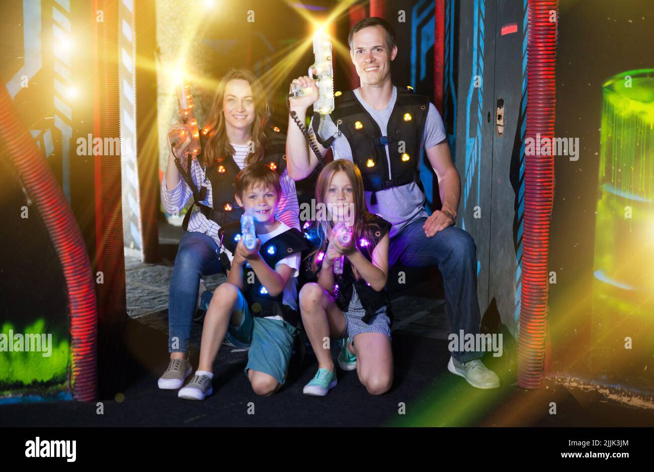 Kids and adults in beams on lasertag arena Stock Photo