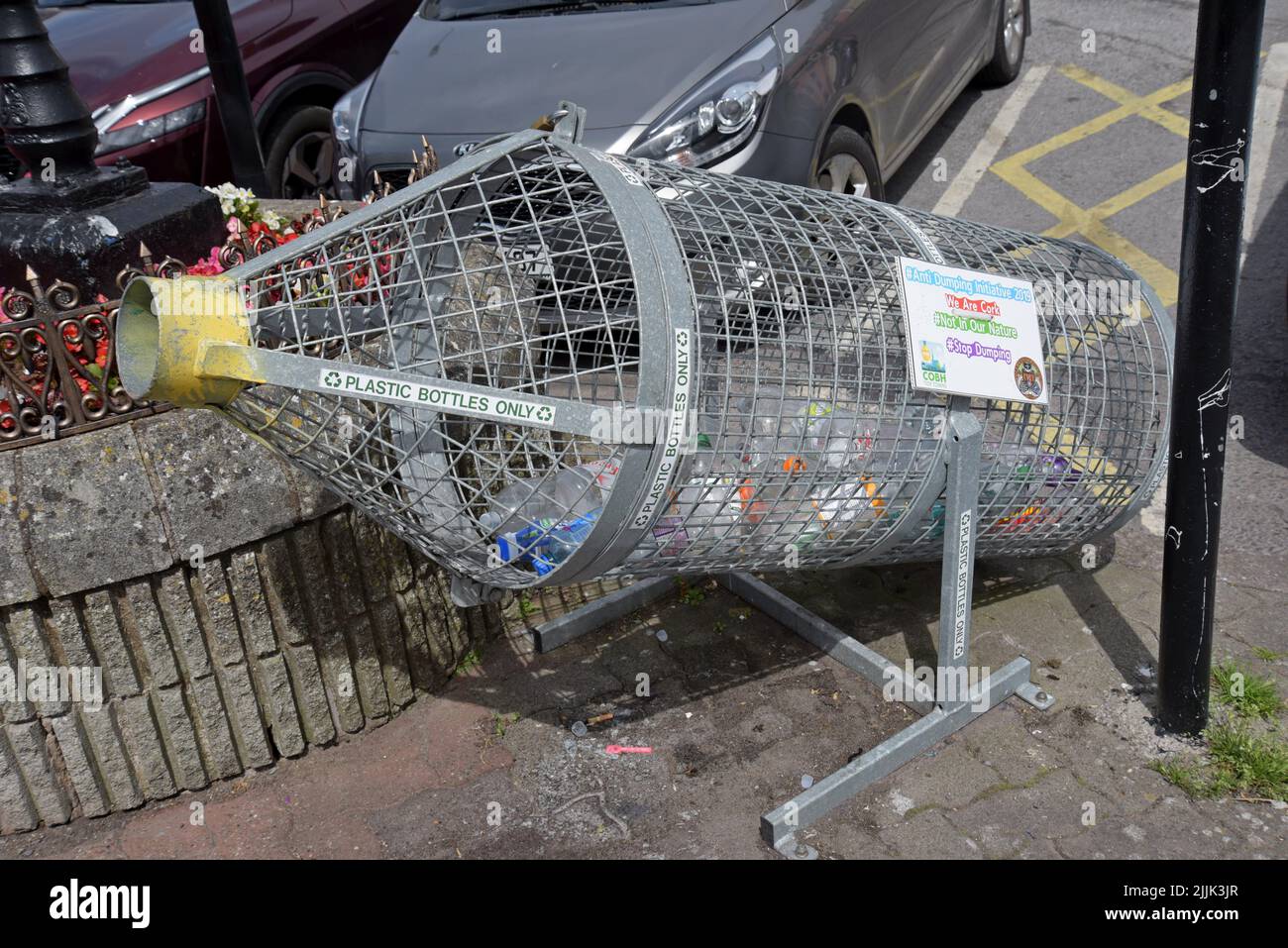 A bottle shaped wire mesh cage for collecting plastic bottles for