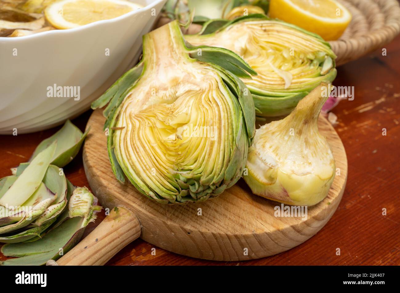 Cooking of green heads of artichokes plants, how to peel raw artichoke