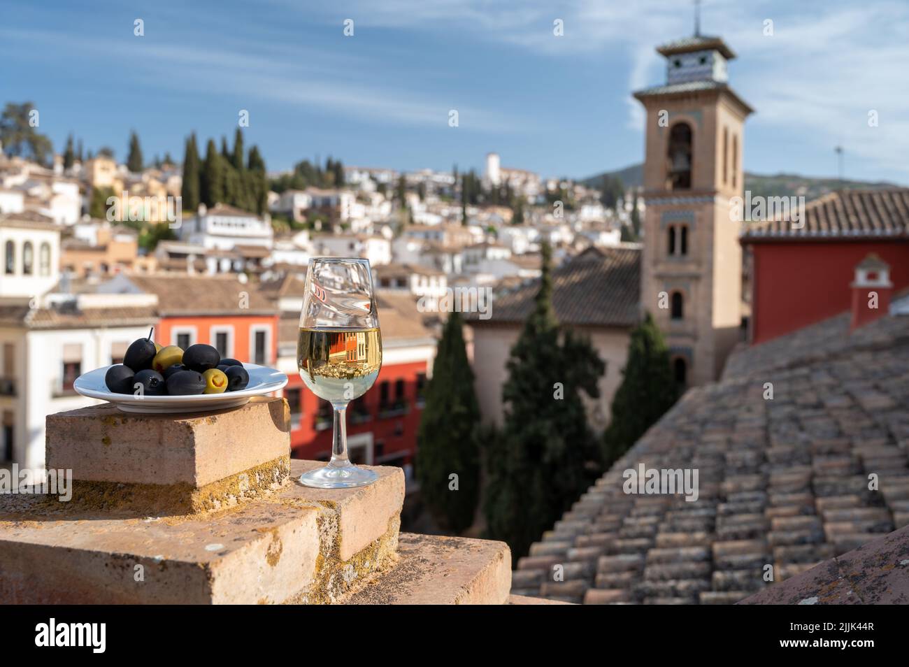 Tasting of Spanish sweet and dry fortified Vino de Jerez sherry wine and olives with view on roofs and houses of old andalusian town, South of Spain Stock Photo