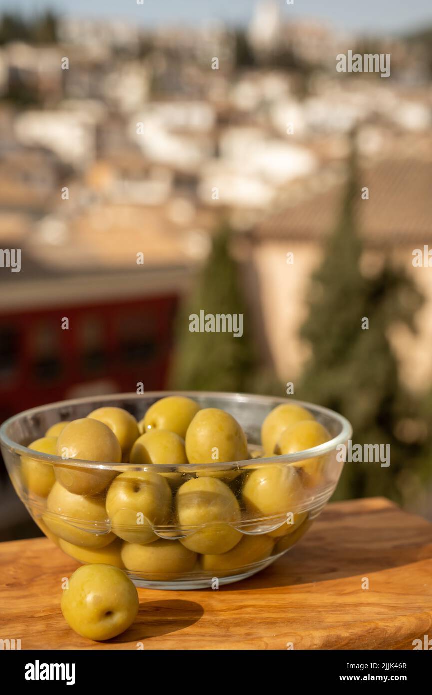 Glass bowl with green andalusian olives served on outdoor terrace with view  on old part and white houses of Granada, Andalusia, Spain Stock Photo -  Alamy