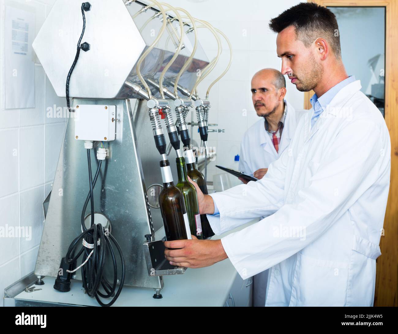 worker with bottling machinery Stock Photo