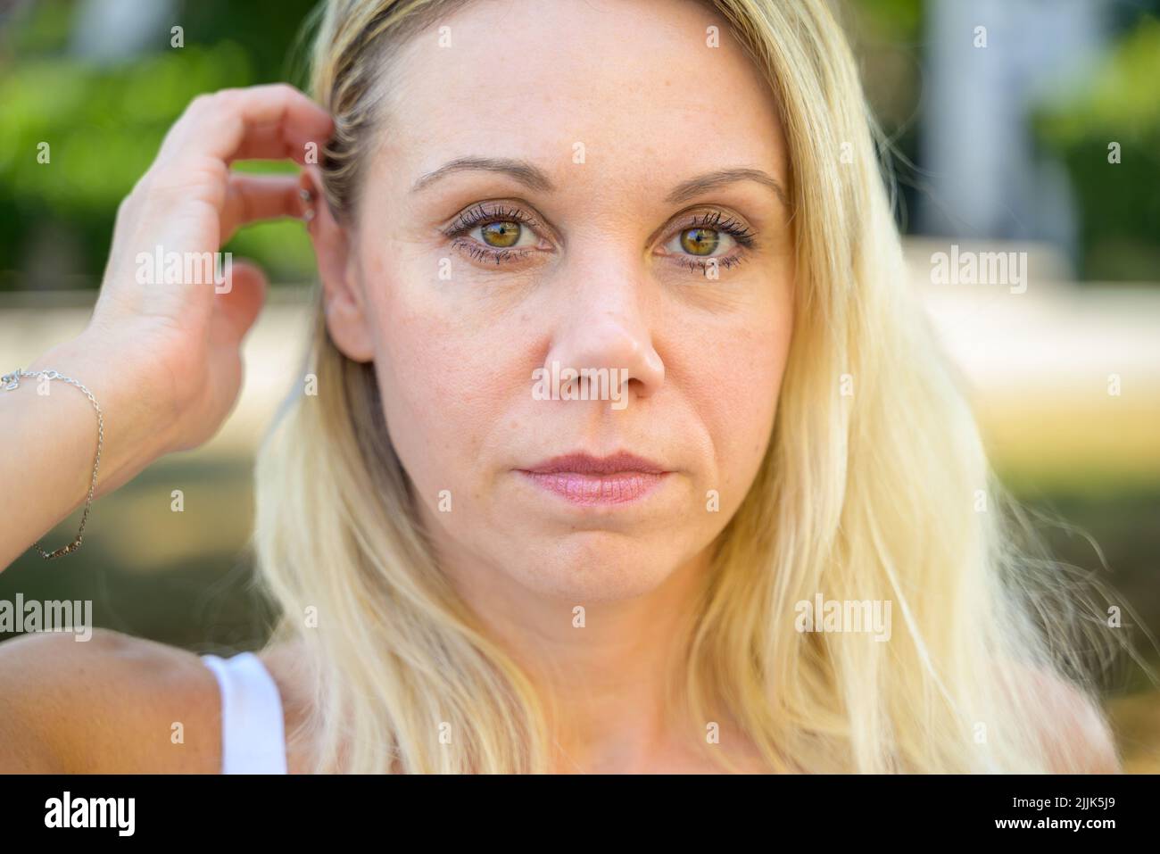 Pensive middle-aged woman looking to the side with a thoughtful ...