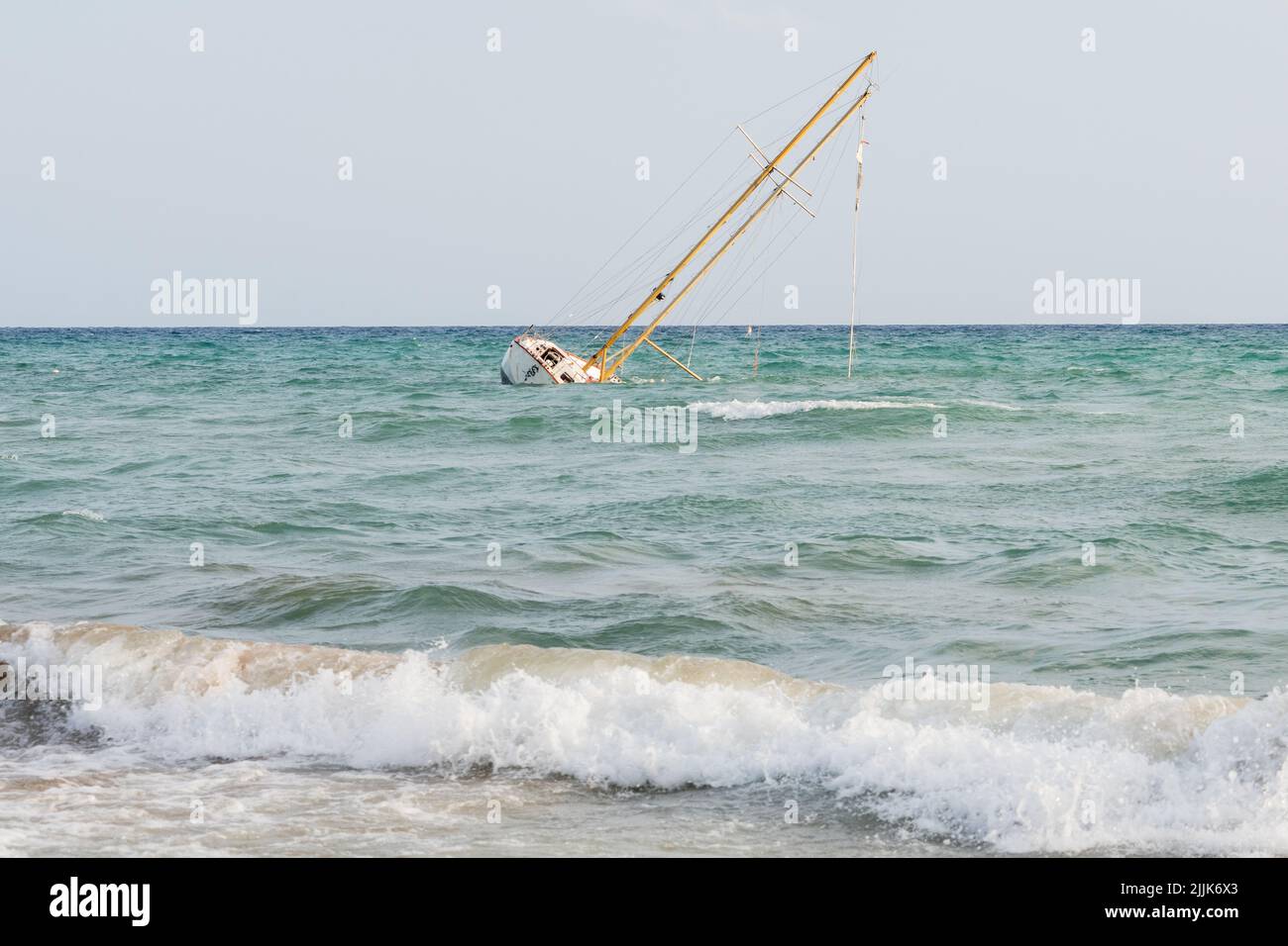 Sailboat stranded near the entrance to the port as a result of getting ...
