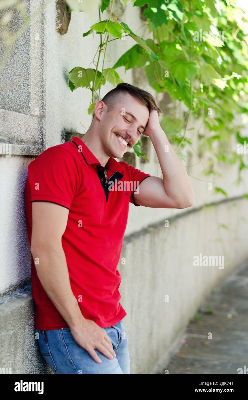 Young happy handsome bearded man, tourist walking in old city of Koper. Summer vacation. Sunglasses. Lifestyle portrait Stock Photo