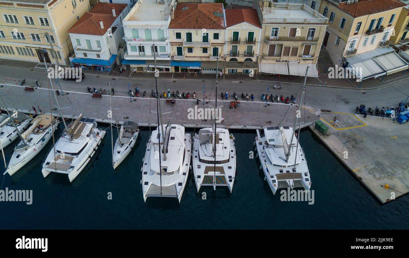 A top view of boats moored at a harbor against buildings in Hydra ...