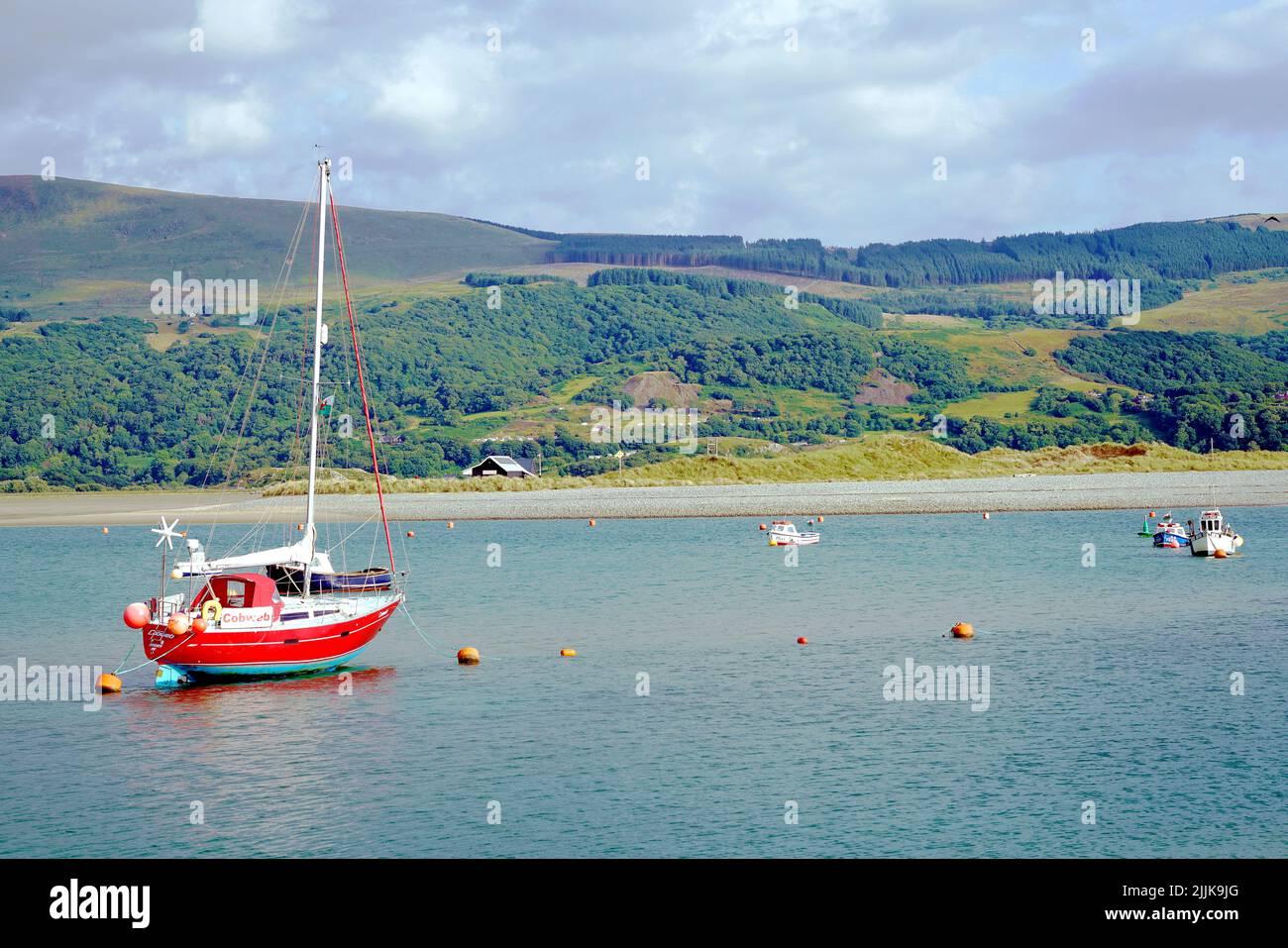 The beautyful countryside and boats on the Mawddach river estuary at Barmouth in Wales in July 2022. Stock Photo