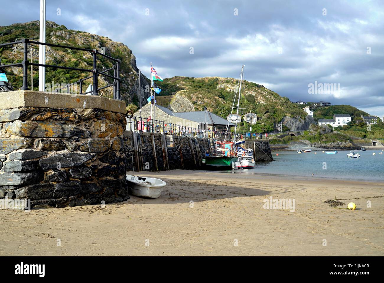 Storm clouds over the Quay and harbour at Barmouth in Gwynedd, Wales. July 2022 . Stock Photo