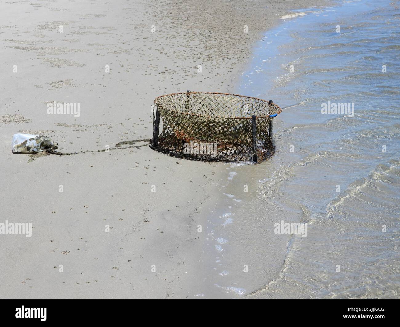 An old crab pot washed ashore, Bribie Island, Queensland, Australia Stock Photo
