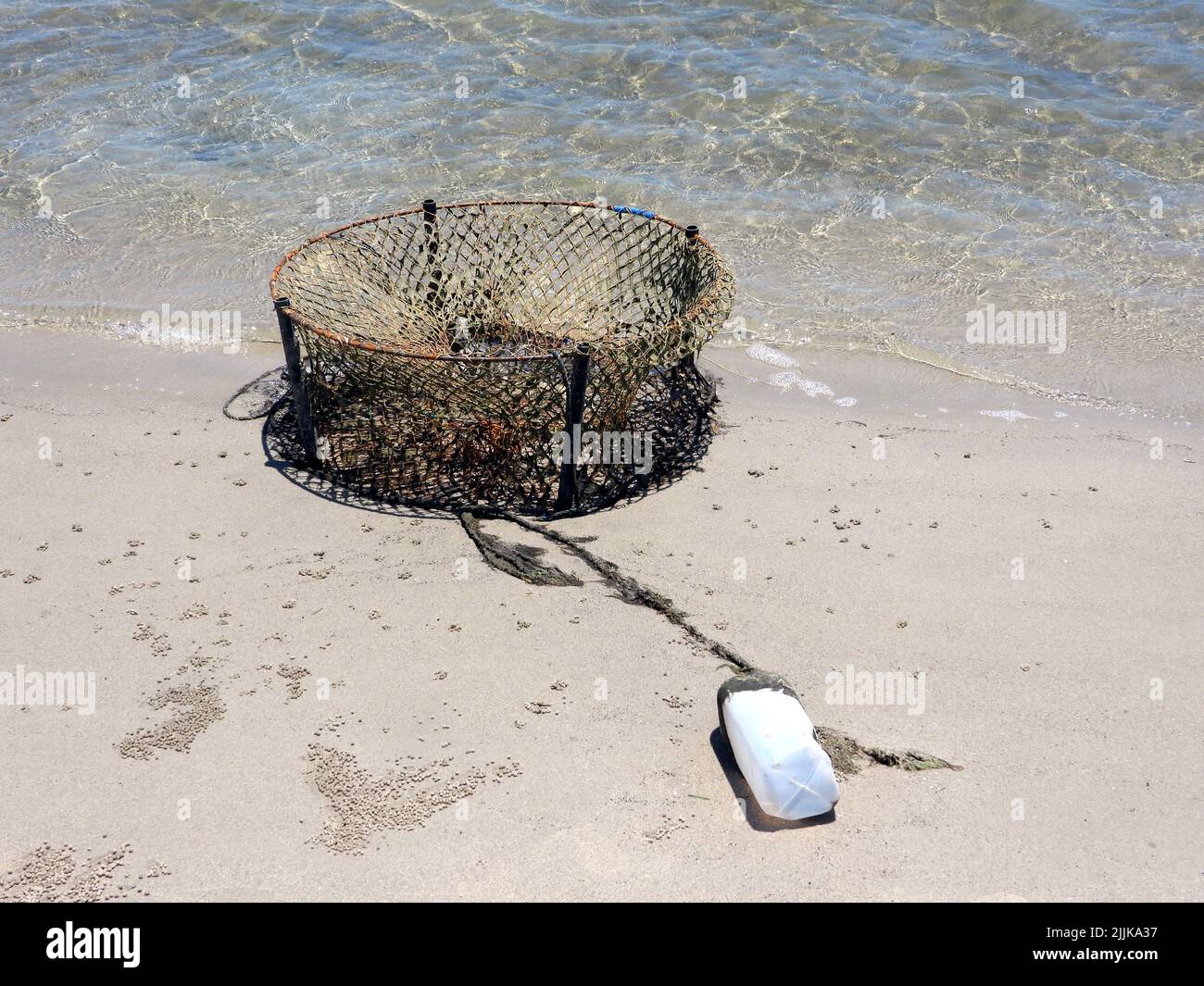 A closeup of a rusty crap pot washed on the beach, Bribie Island