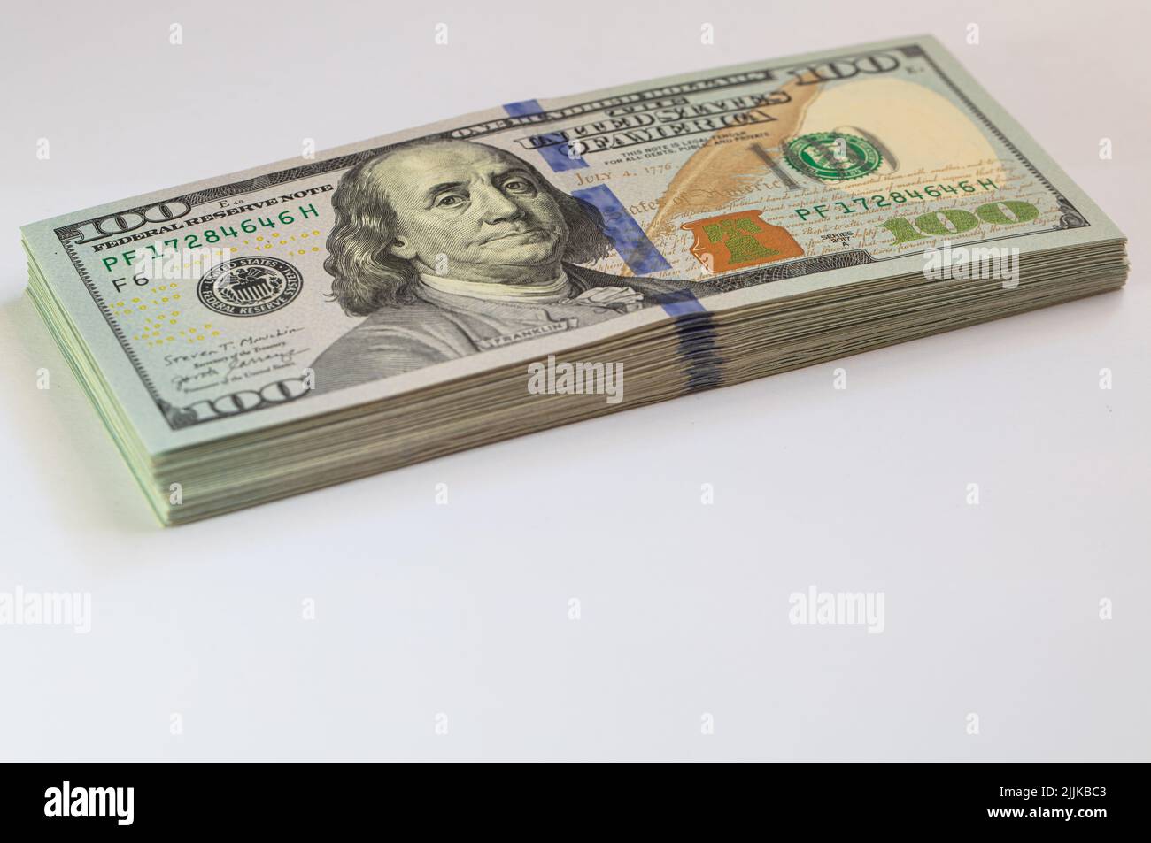 Pile of 100 dollar banknotes on white background for design purpose ...