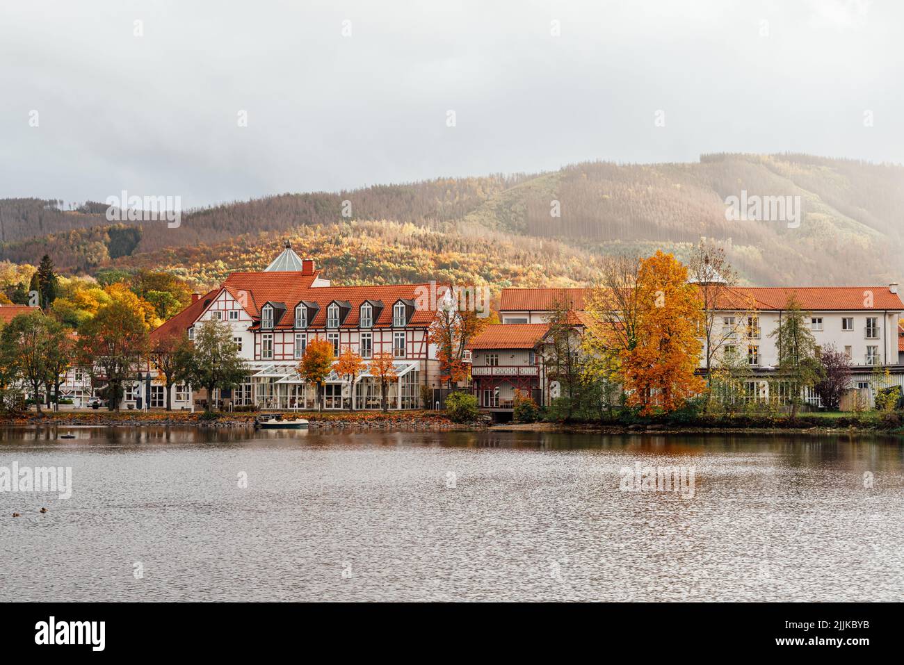 Historic hotel in Ilsenburg with a lake. Colorful autumn colors in the Harz Mountains Stock Photo