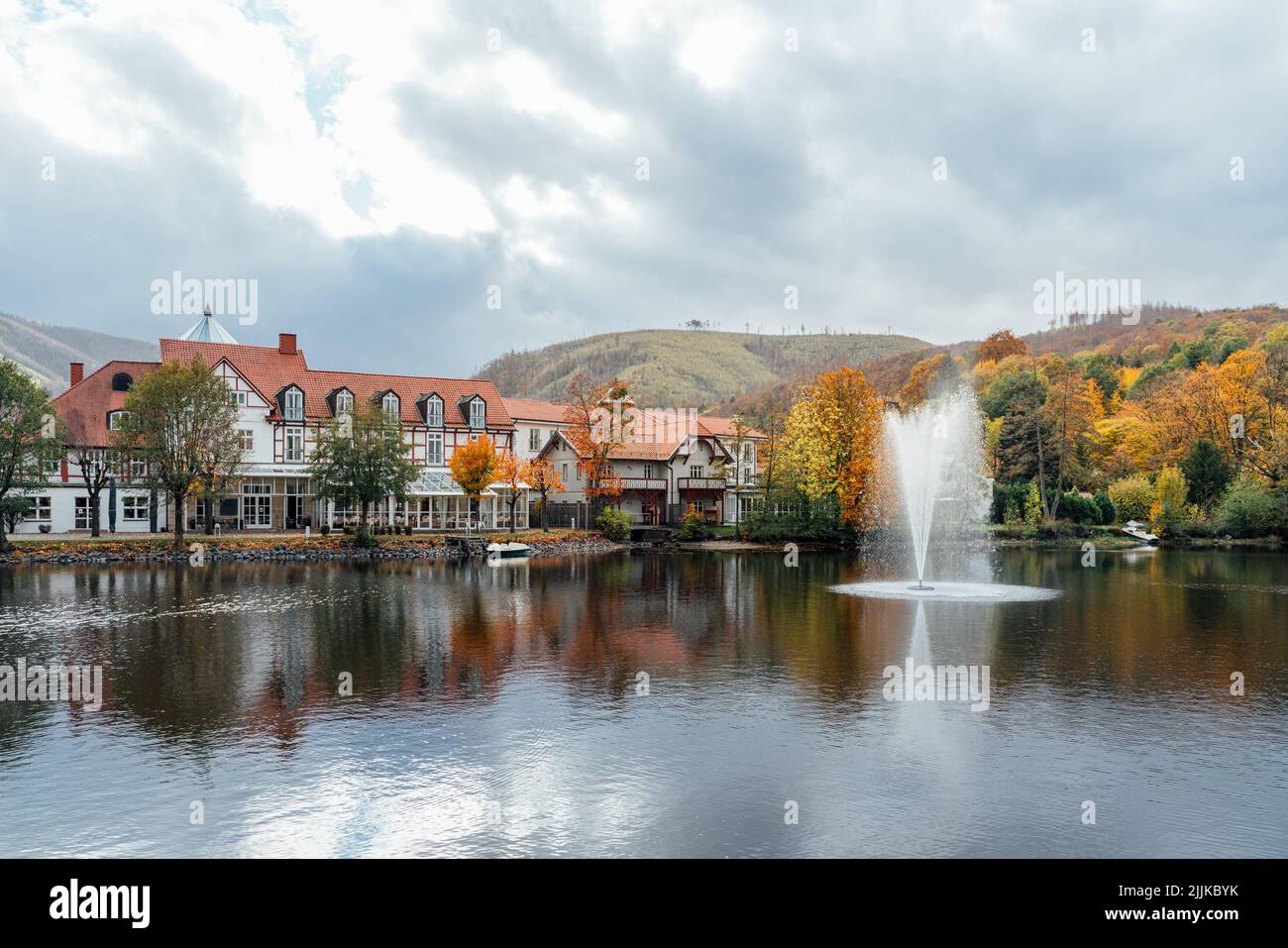 Historical hotel in Ilsenburg with lake and fountain. Colorful autumn colors in the Harz Mountains Stock Photo