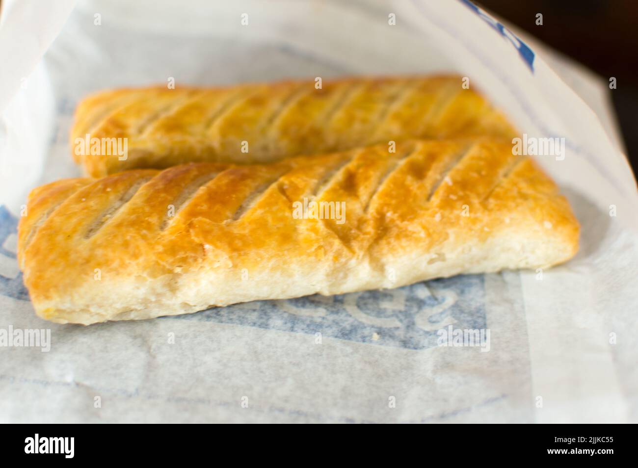 Sausage roll in a white paper bag Stock Photo