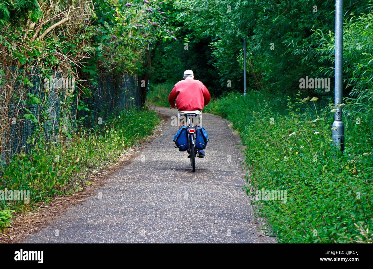 A view of a cyclist on the Marriott's Way long distance path to the north of the City of Norwich, Norfolk, England, United Kingdom. Stock Photo