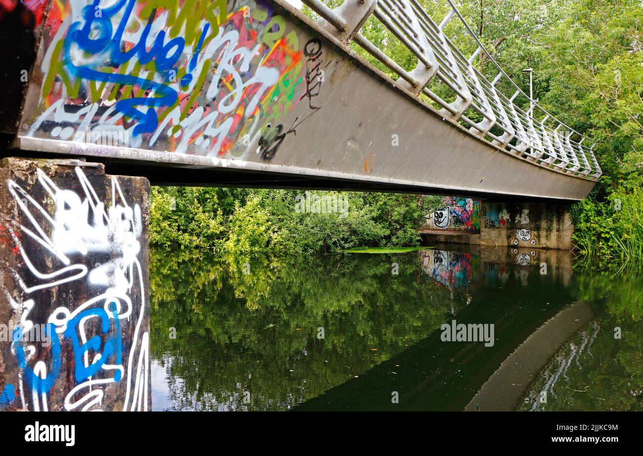 A close-up of the Marriott's Way bridge crossing over the River Wensum with graffiti to the north of the City of Norwich, Norfolk, England, UK. Stock Photo