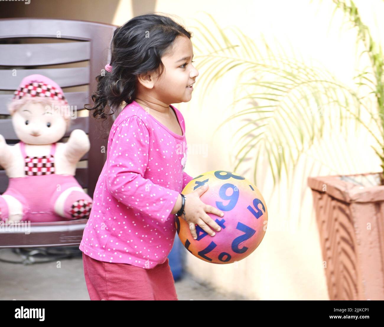 An Indian black-haired girl smiling and playing on the park Stock Photo