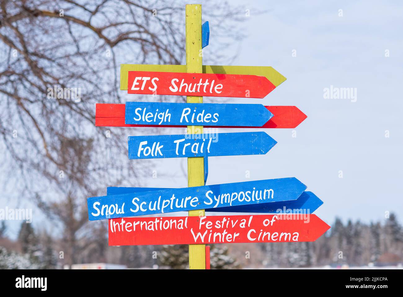 A arrows in post pointing to various activities during winter festival Stock Photo