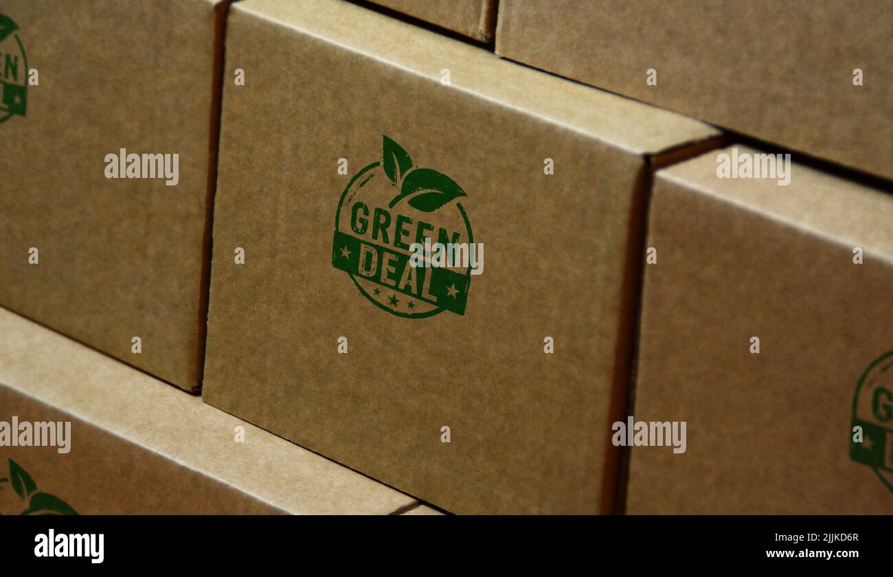 Green Deal stamp printed on cardboard box. European Fit for 55 and reduce the greenhouse gas emissions concept. Stock Photo