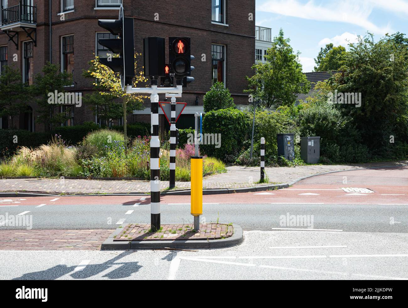Traffic light that is red for pedestrians in Haarlem, the Netherlands. There are no people or trademarks in the shot. Stock Photo
