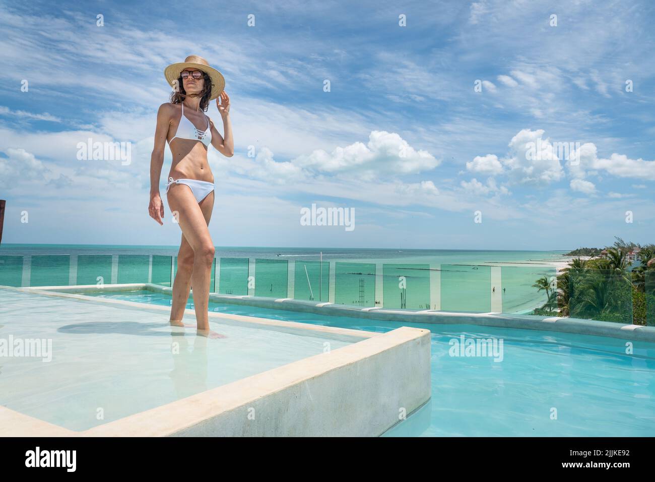 A beautiful Spanish woman in a bikini on a pool in Holbox, Mexico Stock