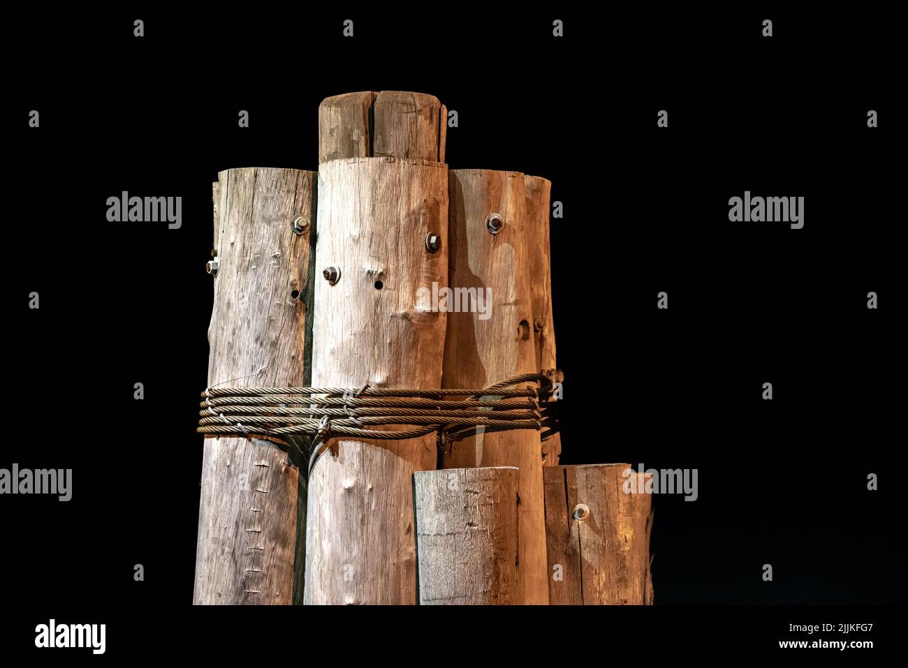 group of pilings on a dark night Stock Photo